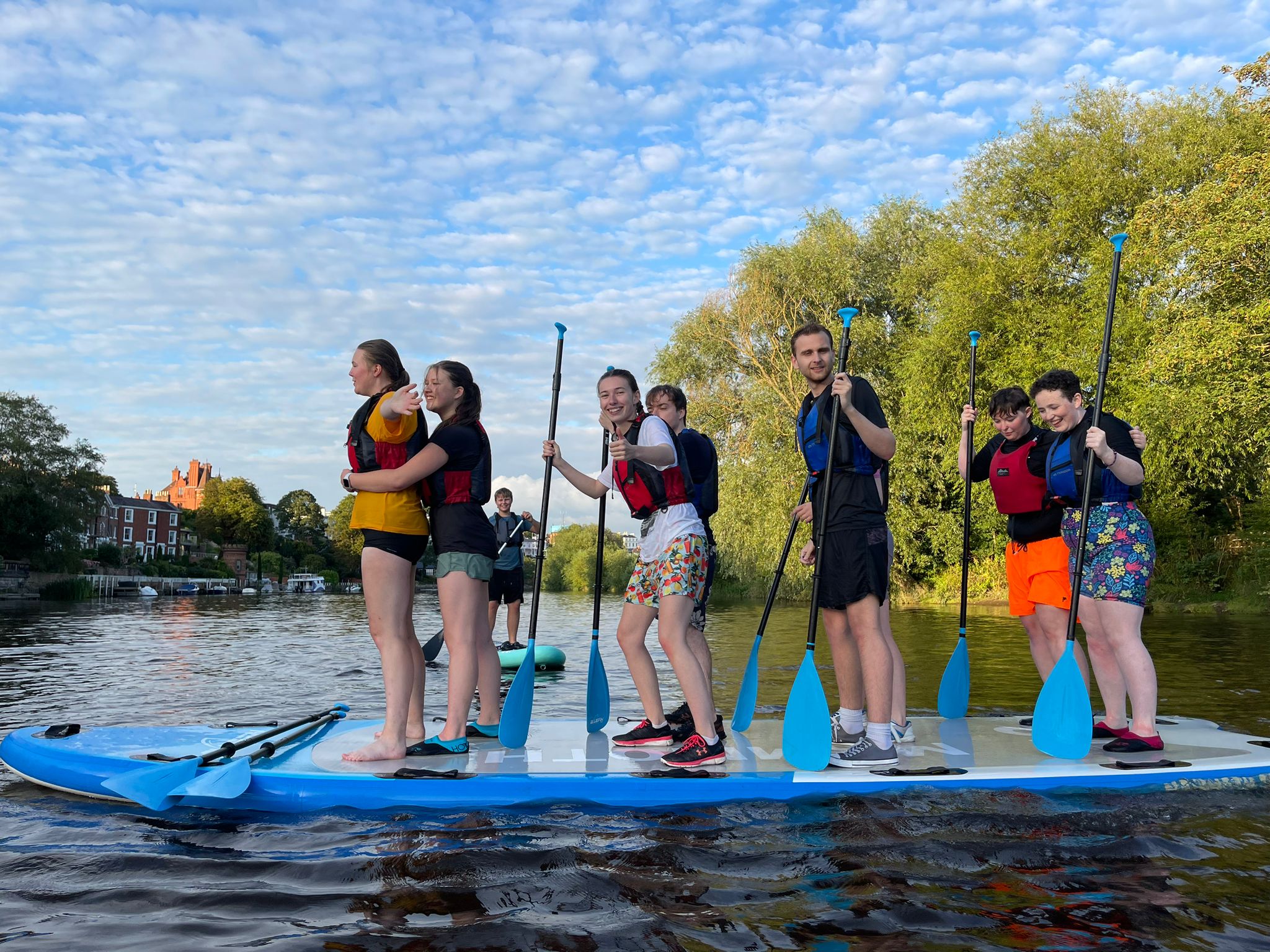 Scouts balancing on a paddle board